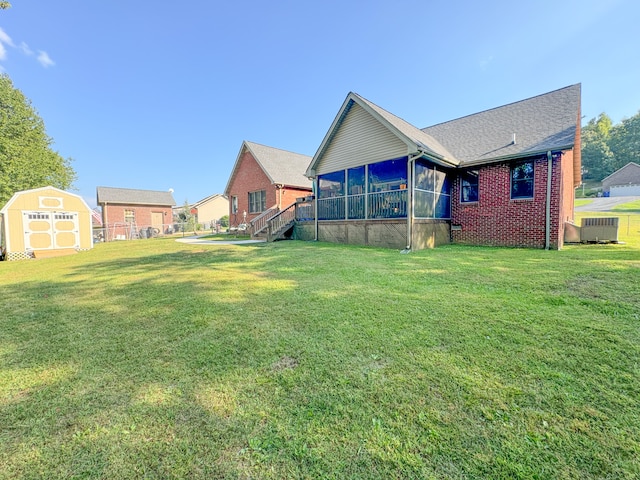 view of yard with a storage unit, cooling unit, and a sunroom