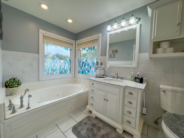 bathroom with vanity, toilet, tile walls, and a bathtub