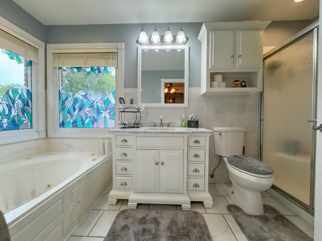 full bathroom featuring tile patterned flooring, separate shower and tub, toilet, tile walls, and vanity