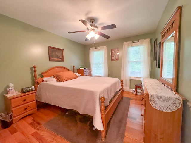 bedroom with hardwood / wood-style floors and ceiling fan