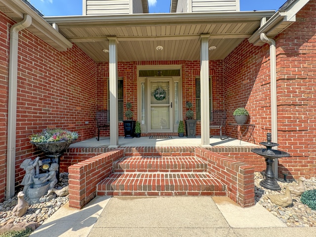 view of exterior entry featuring covered porch