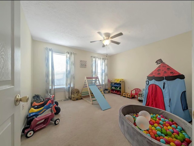 game room with carpet flooring and ceiling fan