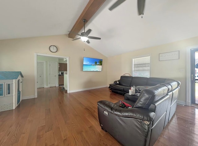 living room with dark hardwood / wood-style flooring, ceiling fan, and vaulted ceiling with beams