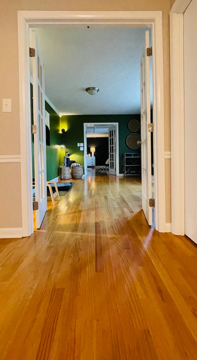 hall with hardwood / wood-style flooring