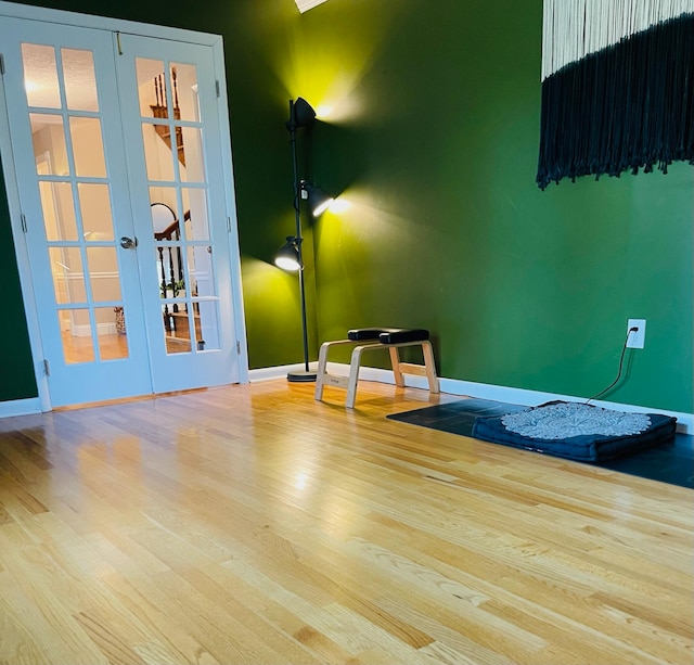 interior space with wood-type flooring and french doors