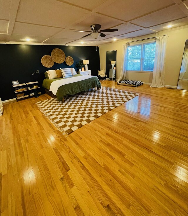 bedroom with coffered ceiling, wood-type flooring, and ceiling fan