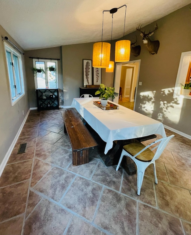 dining room with lofted ceiling