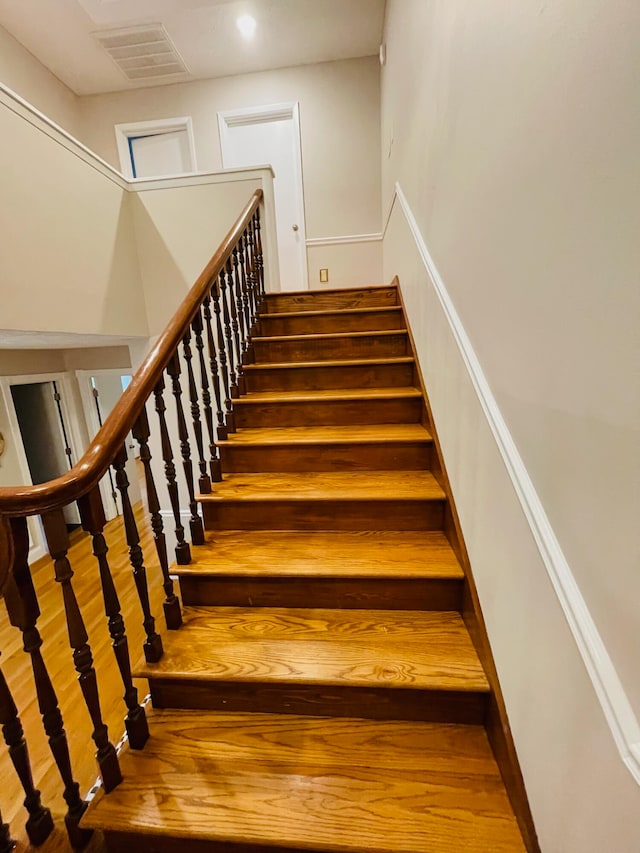 staircase with hardwood / wood-style floors