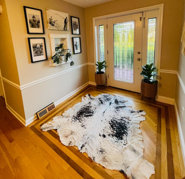 foyer featuring plenty of natural light and wood-type flooring