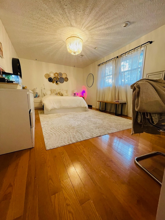 unfurnished bedroom featuring a textured ceiling and wood-type flooring