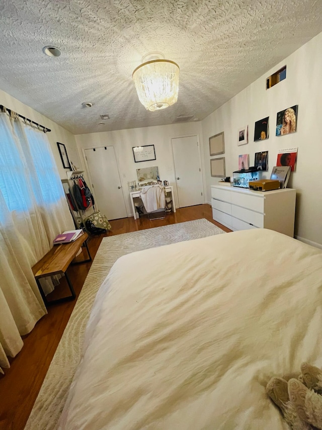 bedroom with wood-type flooring and a textured ceiling