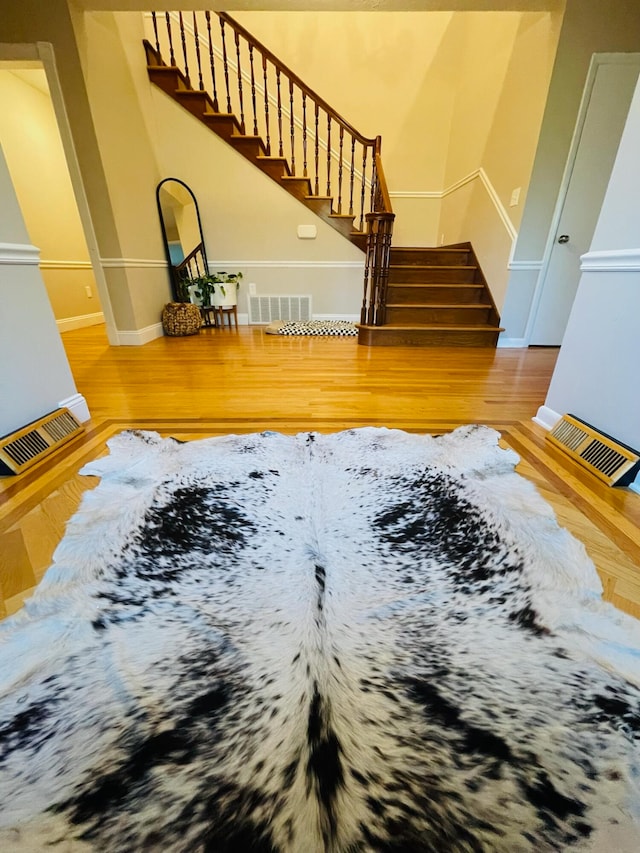 stairway featuring hardwood / wood-style flooring