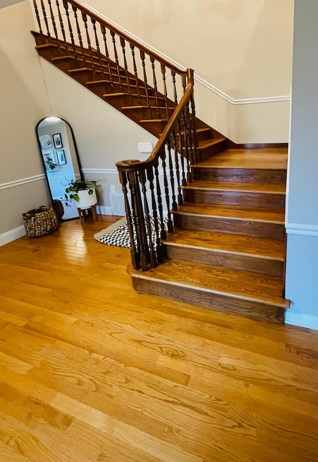 staircase with wood-type flooring