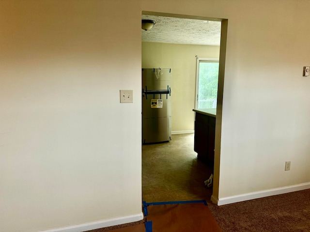 corridor with a textured ceiling