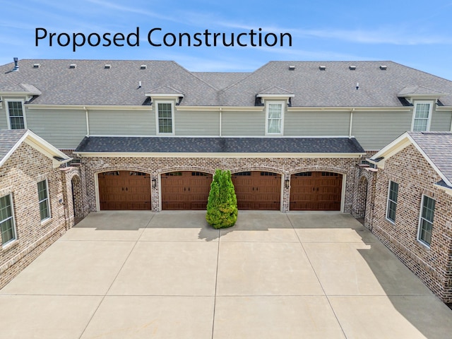 view of home's exterior with brick siding, driveway, and roof with shingles