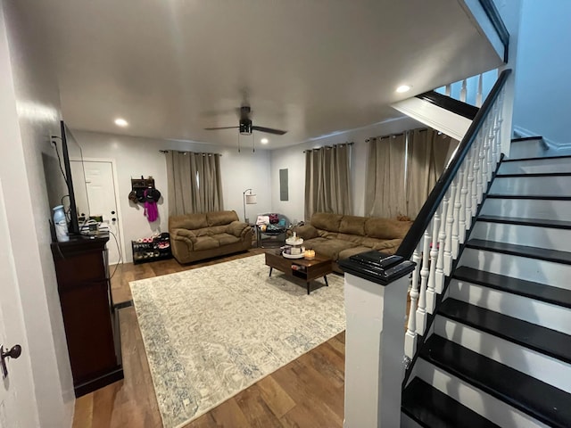 living room with ceiling fan and hardwood / wood-style flooring