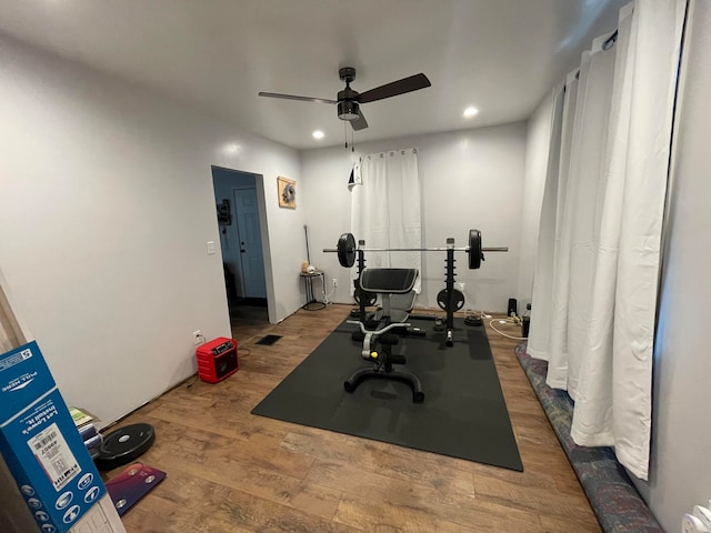 exercise area with ceiling fan and hardwood / wood-style floors