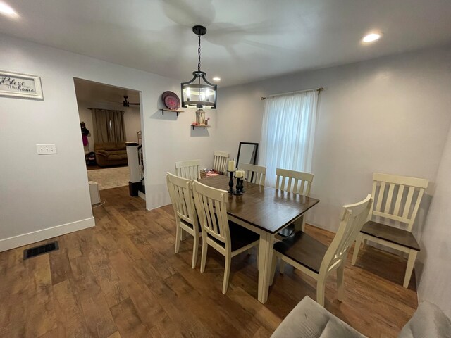 dining room featuring hardwood / wood-style floors and a notable chandelier