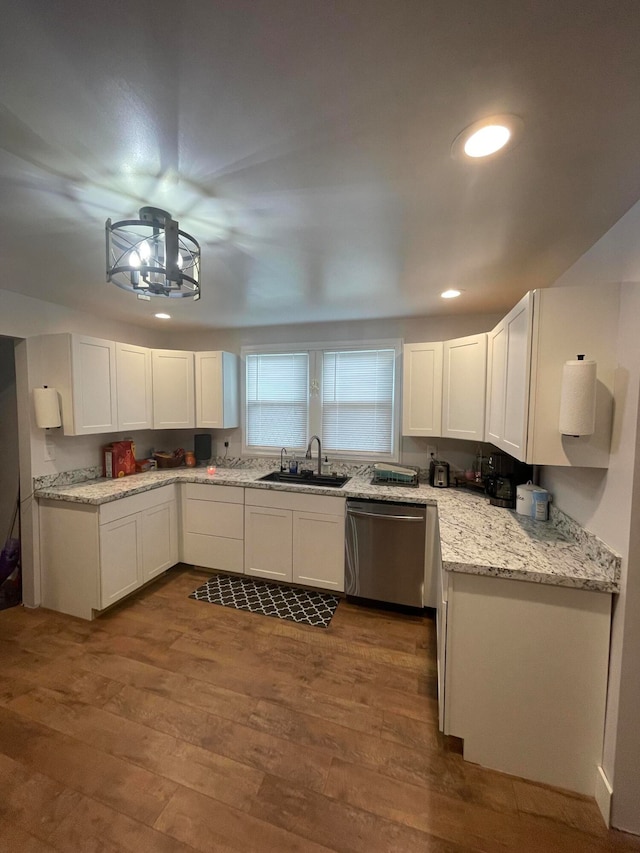 kitchen featuring dishwasher, dark hardwood / wood-style floors, sink, white cabinets, and light stone counters