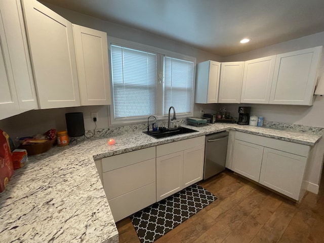 kitchen with sink, light stone countertops, stainless steel dishwasher, white cabinetry, and dark hardwood / wood-style flooring