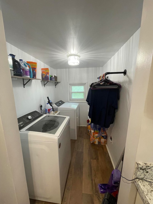 laundry area featuring hardwood / wood-style floors and washing machine and clothes dryer