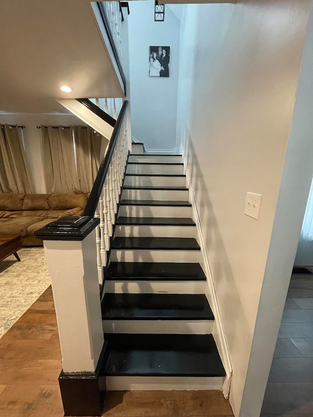 stairway with hardwood / wood-style floors