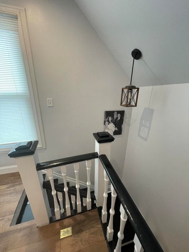 staircase featuring hardwood / wood-style floors and vaulted ceiling