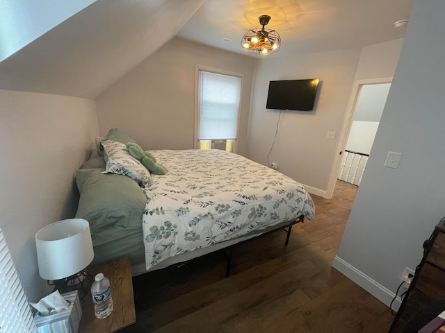 bedroom featuring lofted ceiling and dark hardwood / wood-style floors