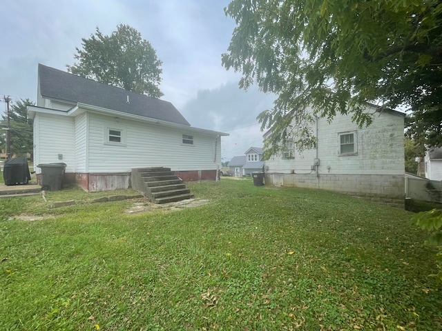 rear view of property featuring a lawn