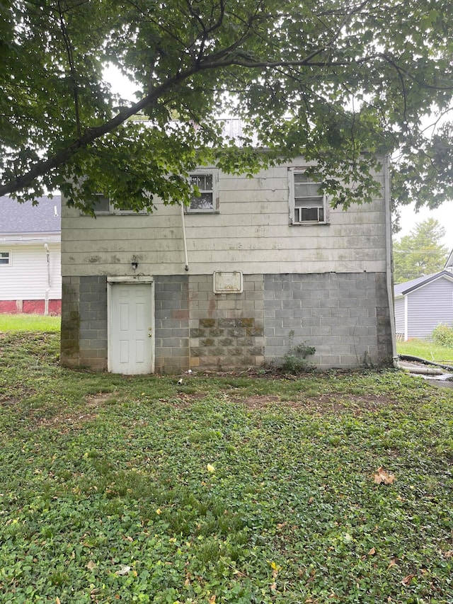 view of property exterior with a lawn