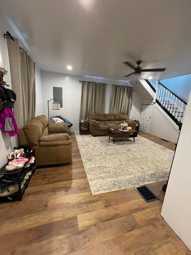 living room featuring hardwood / wood-style floors and ceiling fan