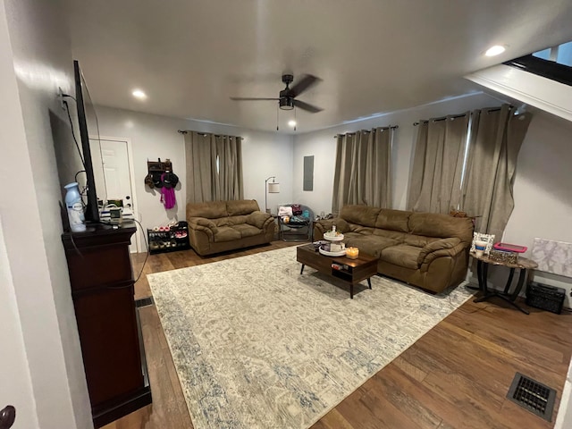 living room featuring hardwood / wood-style floors and ceiling fan