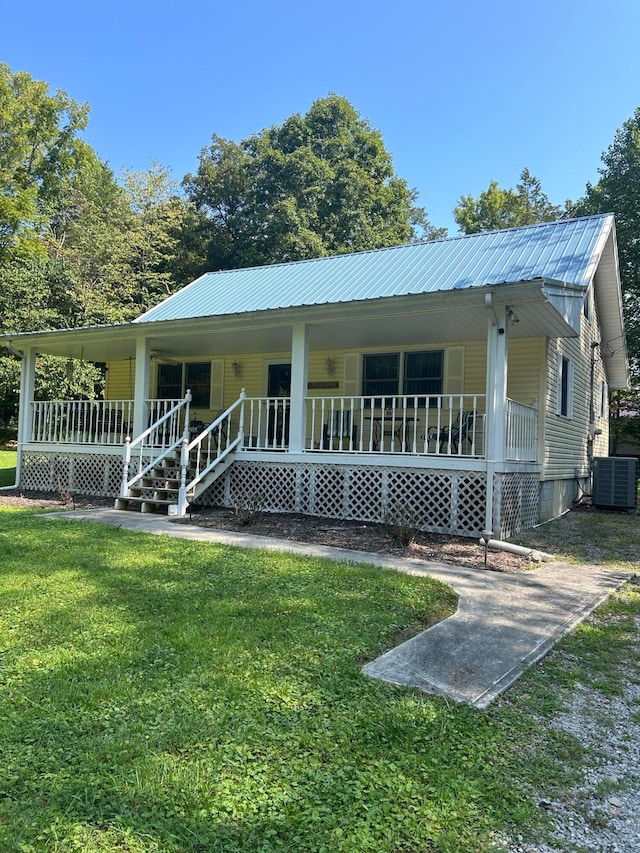 back of property featuring a porch, central AC unit, and a lawn