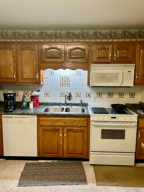 kitchen featuring sink, light tile patterned floors, backsplash, and white appliances