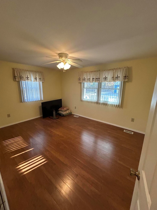 interior space featuring ceiling fan and dark hardwood / wood-style flooring