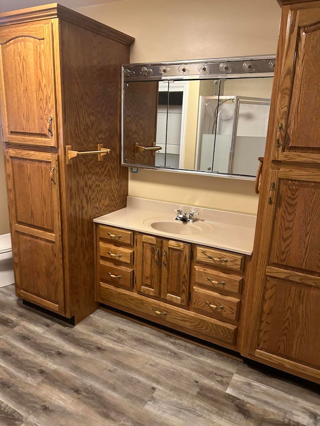 bathroom with vanity, hardwood / wood-style floors, and toilet