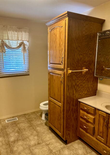 bathroom with vanity and toilet