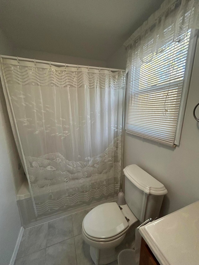 bathroom featuring vanity, toilet, and tile patterned flooring