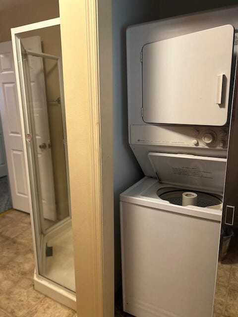 washroom featuring stacked washer and clothes dryer