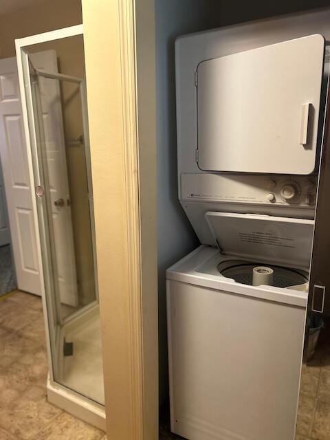 clothes washing area with stacked washer and clothes dryer