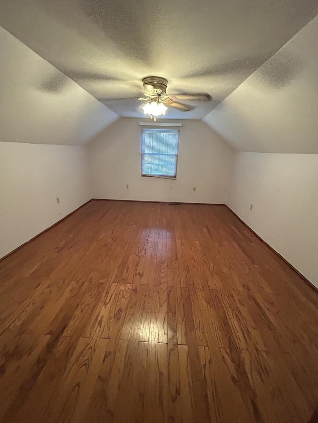 bonus room featuring ceiling fan, hardwood / wood-style flooring, and lofted ceiling