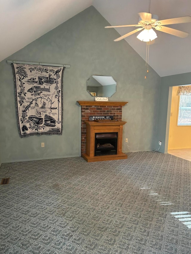 unfurnished living room featuring vaulted ceiling, carpet flooring, and ceiling fan