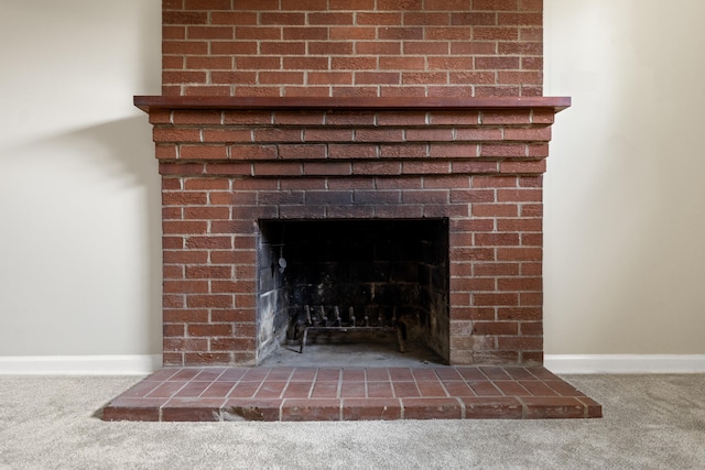 details featuring a fireplace, carpet flooring, and baseboards