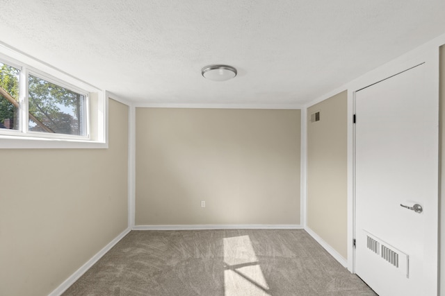 unfurnished bedroom with carpet floors, baseboards, visible vents, and a textured ceiling