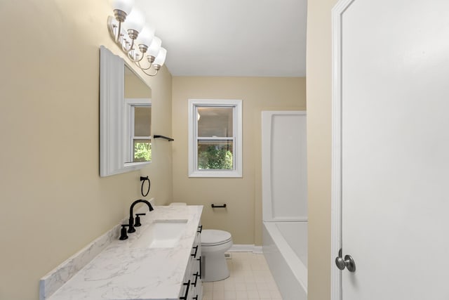 bathroom featuring toilet, a tub, baseboards, and vanity