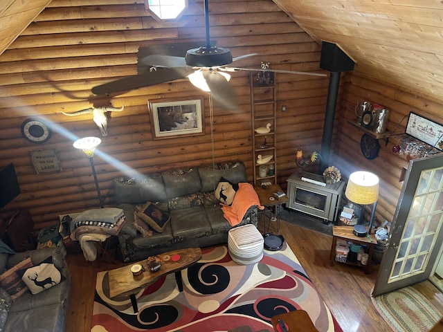 unfurnished living room with log walls and a wood stove