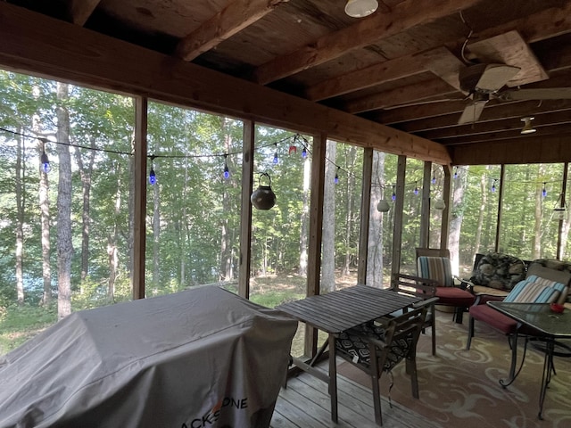 unfurnished sunroom with ceiling fan