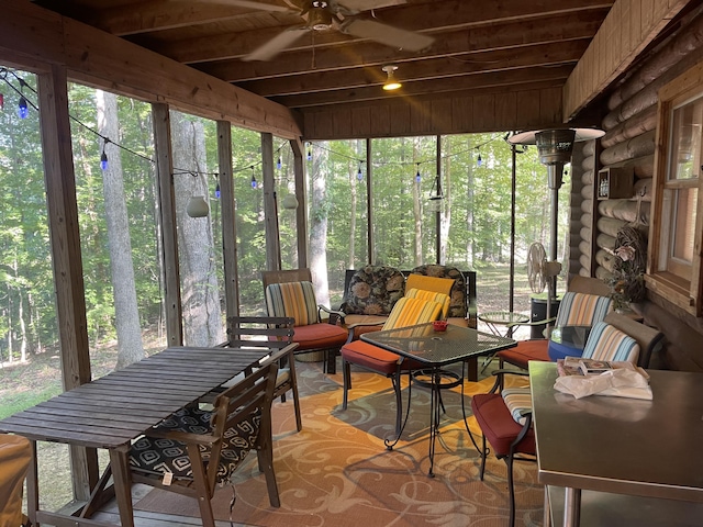 sunroom featuring ceiling fan, wood ceiling, and plenty of natural light