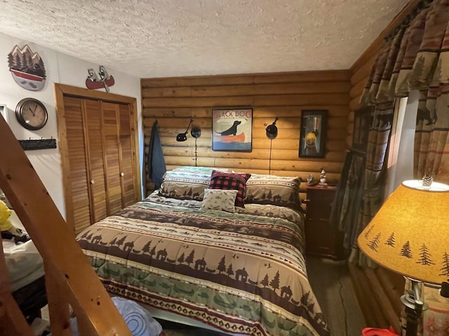 bedroom featuring a textured ceiling, a closet, and log walls