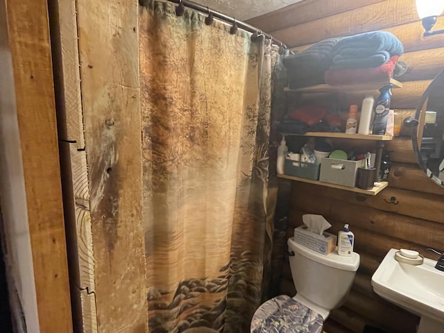 bathroom featuring sink, toilet, walk in shower, and log walls